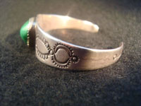 Native American Indian vintage silver jewelry, a Navajo silver bracelet with ingot silver and a beautiful turquoise stone, c. 1920.  Photo of one side of Navajo silver bracelet.