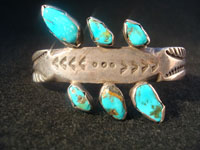 Native American Indian vintage silver jewelry, a Navajo sterling silver bracelet with 6 beautiful turquoise stones, c. 1920. Made from ingot silver, with wonderful early stamping and file marks. This is a treasure for the collector of Native American Indian jewelry! Main photo.
