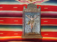 Mexican vintage devotional art, a carved wooden figure of the crucified Christ in a tinwork and glass nicho, c. 1920. The wood carving is covered with gezzo and very beautifully painted. Main photo of the retablo.