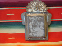 Mexican vintage devotional art, a carved wooden figure of the crucified Christ in a tinwork and glass nicho, c. 1920. The wood carving is covered with gezzo and very beautifully painted. A photo of the back side of the retablo.