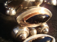 Mexican vintage silver jewelry, a Taxco vintage sterling silver bracelet c. 1940. The bracelet is 980 sterling with beautiful black onyx stones set with copper bezzles. Another closeup photo of the vintage Taxco silver bracelet.
