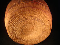 Native American Indian antique Tlingit basket with wonderful geometric bands around the sides, featuring red crosses, c. 1900. A photo of the bottom of the Tlingit basket.