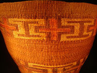 Native American Indian antique Tlingit basket with wonderful geometric bands around the sides, featuring red crosses, c. 1900. A closeup photo of the Tlingit basket.