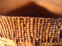 Native American Indian antique Tlingit basket with wonderful geometric bands around the sides, featuring red crosses, c. 1900. A closeup photo of the upper rim of the Tlingit basket.