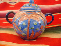 Mexican vintage pottery and ceramics, creamer and suger set by famed artist Balbino Lucano, c. 1920-30. This is one of the finest examples of Balbino's work that we have ever seen. Beautifully decorated with palm trees and animals chasing each other around the pieces! Signed on bottom of sugar, "B D Lucano". Closeup photo.