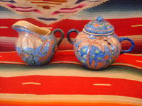 Mexican vintage pottery and ceramics, creamer and suger set by famed artist Balbino Lucano, c. 1920-30. This is one of the finest examples of Balbino's work that we have ever seen. Beautifully decorated with palm trees and animals chasing each other around the pieces! Signed on bottom of sugar, "B D Lucano". Another photo of complete set.