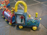 Mexican vintage folk art, and Mexican vintage pottery and ceramics, a pottery train with colorful Mexican passengers, attributed to the very famous folk artist, Candelario Medrano, Santa Cruz de las Huertas, Jalisco, c. 1960. This is a wonderful piece of folk art and an excellent example of Medrano's work!