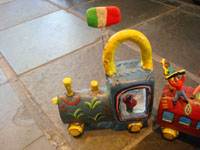 Mexican vintage folk art, and Mexican vintage pottery and ceramics, a pottery train with colorful Mexican passengers, attributed to the very famous folk artist, Candelario Medrano, Santa Cruz de las Huertas, Jalisco, c. 1960. This is a wonderful piece of folk art and an excellent example of Medrano's work! Closeup photo of engine of train.