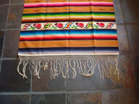 Mexican vintage textiles and sarapes, a lovely Saltillo sarape with a wonderful center diamond of silk, c. 1920's. The predominant color is a lovely golden tan, with very colorful intermittant bands. Closeup photo of one side-bar and fringe.