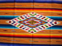 Mexican vintage textiles and sarapes, a lovely Saltillo sarape with a wonderful center diamond of silk, c. 1920's. The predominant color is a lovely golden tan, with very colorful intermittant bands. Photo of center diamond of sarape.