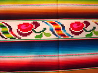 Mexican vintage textiles and sarapes, a lovely Saltillo sarape with a wonderful center diamond of silk, c. 1920's. The predominant color is a lovely golden tan, with very colorful intermittant bands. A closeup of one side-bar.