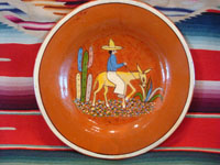 Mexican vintage pottery and ceramics, a lovely terra-cota plate with t scene of a campesino on his donkey, c. 1940's. The scene is very endearing and lovely. Condition is excellent.