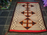 Native American Indian vintage textiles, a Navajo Crystal rug with striking crosses, c. 1920-30's. The design of the weaving is powerful, and the colors are vibrant and bold. Main photo of rug.