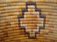 Native American Indian baskets, an incredibly beautiful Mission Indian basket with very colorful natural and dyed juncus, Southern California, c. 1920's. Closeup photo of one of the crosses of the Mission Indian basket.