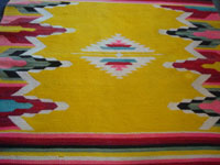 Mexican vintage textiles, serapes, huipiles, a lovely woven woolen textile with a beautiful yellow background and wonderful decorations, Tlaxcala, c. 1940. Closeup photo of the center of the textile.