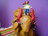 Mexican vintage folk art, a wonderful pottery bull with six steers and six caballeros across its massive back, made by the famous folk artist, Rosendo Rodriguez, of Santa Cruz de las Huertas, Jalisco, c. 1980. Photo shot from the front looking at the bull's head.