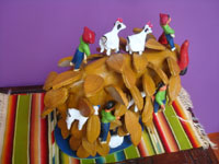 Mexican vintage folk art, a wonderful pottery bull with six steers and six caballeros across its massive back, made by the famous folk artist, Rosendo Rodriguez, of Santa Cruz de las Huertas, Jalisco, c. 1980. A side view of the bull.