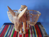 Mexican vintage folk art, a carved wooden donkey with woven baskets at both sides, Michoacan, c. 1980's. Another side view of the donkey.