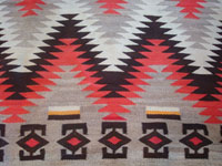 Native American Indian vintage textile, a Navajo Red-Mesa weaving, c. 1930-1940. The border shows a Tees Nos Pas influence. Very well woven with an eye-dazzler center design. A closeup photo of the Red Mesa textile.