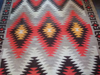 Native American Indian vintage textile, a Navajo Red-Mesa weaving, c. 1930-1940. The border shows a Tees Nos Pas influence. Very well woven with an eye-dazzler center design. A second closeup photo of the Red Mesa.