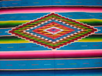 Mexican vintage sarape and textile, a Saltillo sarape, c. 1930's. Beautiful turquoise field. Very finely woven of wool and with a dynamite center diamond and end-bars of silk. Photo of center medallion.
