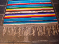Mexican vintage sarape and textile, a Saltillo sarape, c. 1930's. Beautiful turquoise field. Very finely woven of wool and with a dynamite center diamond and end-bars of silk. Photo of one end of the Saltillo sarape.