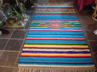 Mexican vintage sarape and textile, a Saltillo sarape, c. 1930's. Beautiful turquoise field. Very finely woven of wool and with a dynamite center diamond and end-bars of silk. Main photo.
