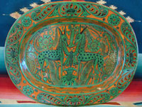 Mexican vintage pottery and ceramics, a very lovely fantasia (fantasia-ware) oval charger with very intricate and imaginative decorations, Tonala or Tlaquepaque, Jalisco, c. 1940. Main photo of the fantasia-ware oval charger.