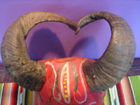 Mexican vintage woodcarvings and masks, a wonderful wooden mask depicting a devil and used in ceremonial dances, Guerrero, c. 1940's. Closeup photo of the real goat horns adorning the mask.