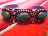 Native American Indian sterling silver jewelry, and Navajo vintage sterling silver jewelry, a beautiful Fred Harvey silver bracelet with wonderful stamping and lovely turquoise stones each showing a beautiful matrix, Arizona or New Mexico, c. 1930's. Closeup photo of part of the bracelet showing the beautiful turquoise stones.
