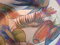 Mexican vintage pottery and ceramics, a lovely burnished pottery charger with graceful floral decorations of gorgeous bromiliads, Tonala, c. 1930's. Closeup photo of some of the floral decorations.