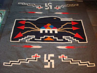 New Mexican vintage textile, a finely woven rug from the weaving center of Chimayo, New Mexico, c. 1930. This is from a very famous weaver, active from 1910-40, whose signature was the hummingbird in the center of this textile. Photo of hummingbird in center of textile.