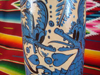 Mexican vintage pottery and ceramics, a large Fantasia-style pitcher, Tlaquepaque, c. 1930. Whimsical blue decorations on a cream-colored glaze, with dragons, flowers, leaves; all exquisitely painted. A closeup.