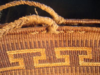 Native American Indian basket, a Northwest Coast twined purse, Tsimshian, c. 1900-10. Beautifully woven of cedar bark with geometric imbricated decoration and woven cedar bark handles. Closeup.