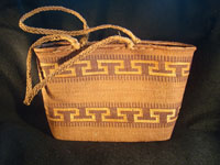 Native American Indian basket, a Northwest Coast twined purse, Tsimshian, c. 1900-10. Beautifully woven of cedar bark with geometric imbricated decoration and woven cedar bark handles. Main photo.