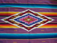Mexican vintage textile, a wonderful Saltillo sarape, c. 1930. Very finely woven of wool with silk in the center diamond and decorative side-bars, and complete fringe. Closeup of center.
