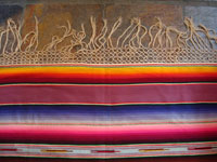Mexican vintage textile, a wonderful Saltillo sarape, c. 1930. Very finely woven of wool with silk in the center diamond and decorative side-bars, and complete fringe. Closeup of one edge with fringe.