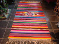 Mexican vintage textile, a wonderful Saltillo sarape, c. 1930. Very finely woven of wool with silk in the center diamond and decorative side-bars, and complete fringe. Main photo.