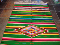 Mexican vintage sarapes and textiles, a beautiful Saltillo sarape with a green background and wonderful center diamond of silk, c. 1930's. Photo of the top half of the sarape.