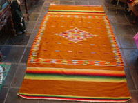 Mexican vintage sarapes and textiles, a rare and very beautiful Saltillo sarape with a tan/gold background and beautiful center medallion and rainbow border, c. 1900. Main photo of the Saltillo sarape.