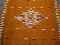 Mexican vintage sarapes and textiles, a rare and very beautiful Saltillo sarape with a tan/gold background and beautiful center medallion and rainbow border, c. 1900. Photo of the lovely center diamond of the Saltillo sarape.