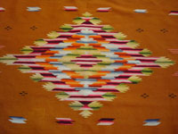 Mexican vintage sarapes and textiles, a rare and very beautiful Saltillo sarape with a tan/gold background and beautiful center medallion and rainbow border, c. 1900. An even closer photo of the center diamond of the Saltillo sarape.