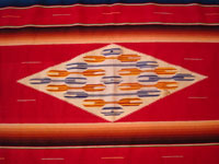 Mexican vintage textiles and sarapes, a beautiful Saltillo sarape with a red background, c. 1940's. The center medallion is spectacular, and the colors on both front and back are bright and vibrant. Main photo of the Saltillo sarape. Photo showing the center diamond of the Saltillo sarape.
