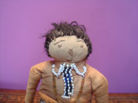 Native American vintage folk art, a wonderful Navajo doll with a beaded blouse and broom skirt, Arizona or New Mexico, c. 1940. Closeup photo of the doll's face.