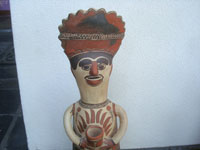 Mexican vintage folk art, a pottery statue of a shaman, Guerrero, c. 1960. The statue is beatifully formed and decorated. The statue is from the village of Amayaltepic. Closeup photo of the shaman's face.