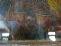 Mexican vintage devotional art and Mexican vintage tin-work art, a wonderful nicho with a retablo of Our Lady of Guadalupe; retablo on tin c. 1920. The lovely tin-work nicho is c. 1930-40, with wonderful inverted painting decorating the frame. A closeup photo of the angel at the feet of the Virgin.