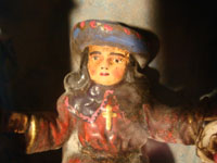 Mexican vintage devotional art, and Mexican vintage folk art, a wooden nicho with a bulto (carved wooden statue) of the Santo Nino de Atocha, c. 1940. This is a beautiful piece of vintage Mexican fine/folk art! Closeup photo of the face of the Santo Nino.