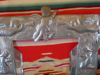 Mexican vintage tinwork-art, a beautifully stamped tin-work frame, c. 1950. The stamping work on this tin frame is magnificent, and features lovely cherubs and angels. A closeup photo