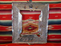 Mexican vintage tinwork-art, a beautifully stamped tin-work frame, c. 1950. The stamping work on this tin frame is magnificent, and features lovely cherubs and angels. Photo of back of the tinwork frame.