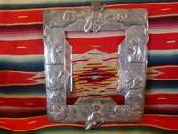 Mexican vintage tinwork-art, a beautifully stamped tin-work frame, c. 1950. The stamping work on this tin frame is magnificent, and features lovely cherubs and angels. Main photo.